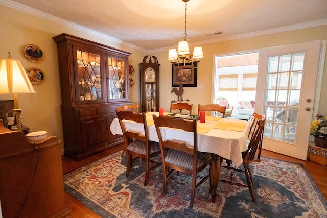 dining room featuring a notable chandelier, crown molding, and dark hardwood / wood-style floors