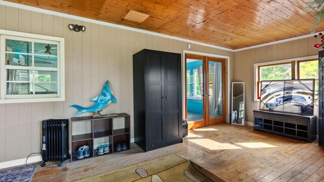 261 Buzzard Roost Rd, Bulls Gap, TN 37711 - foyer with radiator heating unit, hardwood / wood-style flooring, wood ceiling, crown molding, and wooden walls