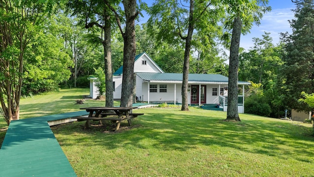 261 Buzzard Roost Rd, Bulls Gap, TN 37711 - view of front of house featuring a porch, a front yard, metal roof, and view of wooded area