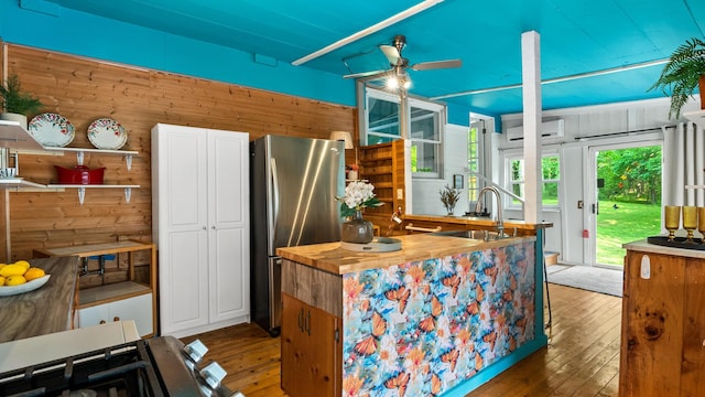 261 Buzzard Roost Rd, Bulls Gap, TN 37711 - kitchen featuring a sink, freestanding refrigerator, a ceiling fan, wood walls, and wooden counters