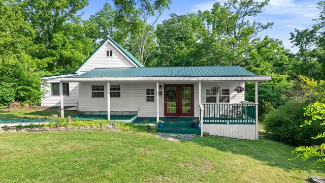 261 Buzzard Roost Rd, Bulls Gap, TN 37711 - view of front of house featuring a front lawn, french doors, metal roof, and a porch