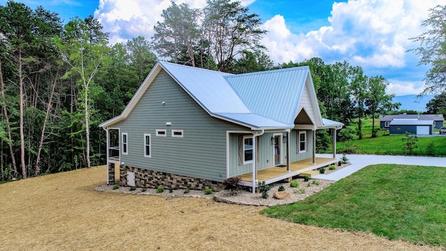 1056 Old Newport Hwy, Dandridge, TN 37725 - view of home's exterior with a porch, a yard, and a metal roof
