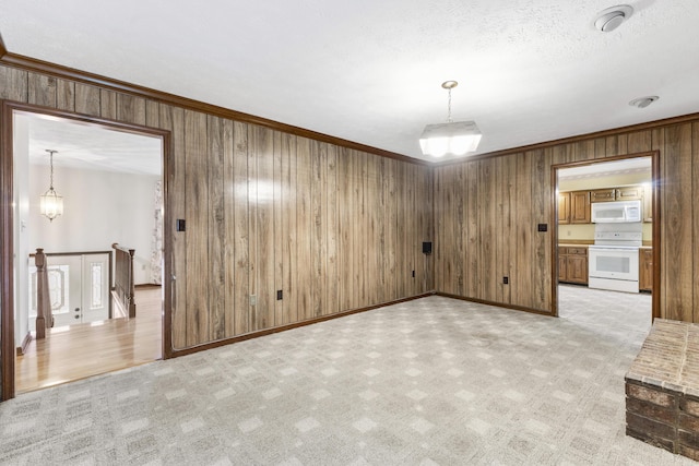 interior space featuring ornamental molding, a textured ceiling, and a notable chandelier