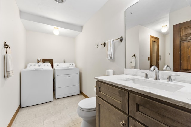 bathroom featuring vanity, toilet, and separate washer and dryer