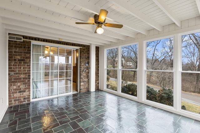 unfurnished sunroom featuring beam ceiling, ceiling fan, and plenty of natural light