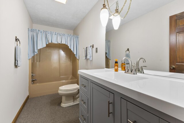 full bathroom featuring a textured ceiling, vanity, toilet, and shower / washtub combination