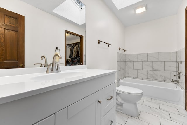 bathroom featuring vanity, toilet, and a skylight