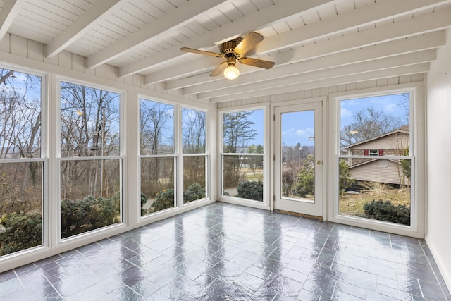 unfurnished sunroom featuring beamed ceiling and ceiling fan