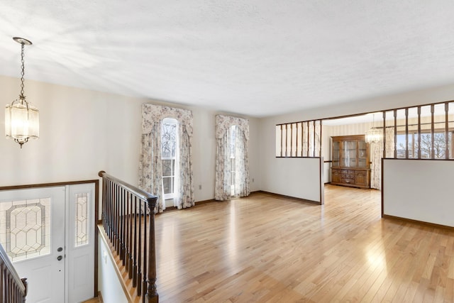 foyer with a chandelier and light hardwood / wood-style floors