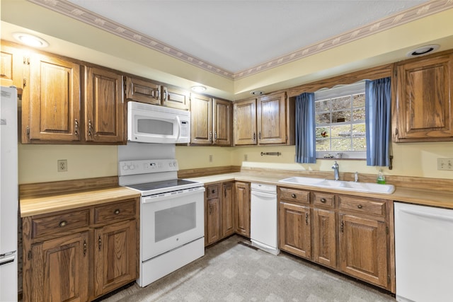 kitchen featuring white appliances and sink