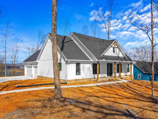 modern farmhouse style home with roof with shingles, board and batten siding, driveway, a porch, and a garage