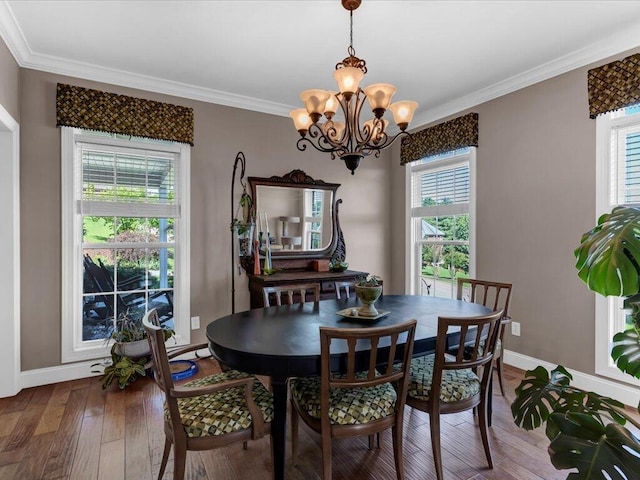 dining room with a wealth of natural light, crown molding, a chandelier, and wood-type flooring