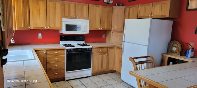 kitchen featuring tile counters, white appliances, light tile patterned flooring, and brown cabinetry