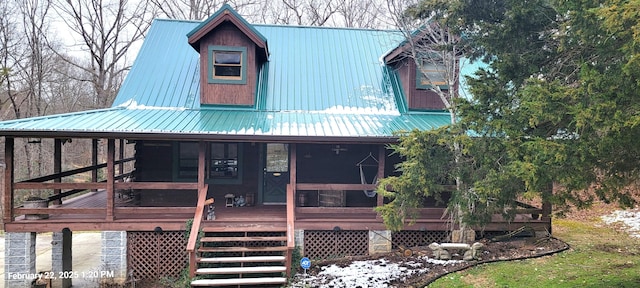 view of front facade with metal roof and a wooden deck