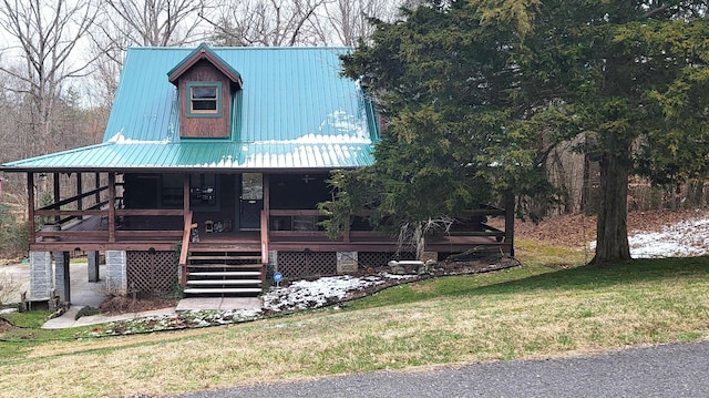 view of front of home with metal roof and a front yard