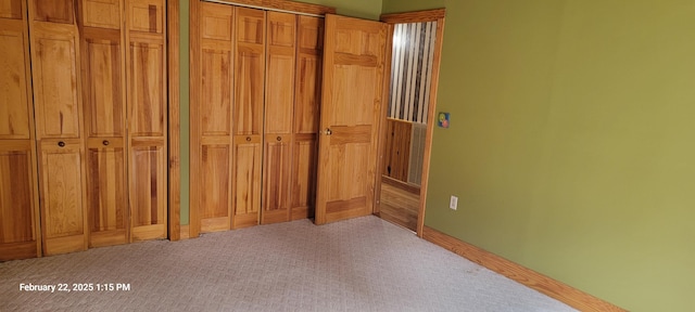 unfurnished bedroom with carpet floors and baseboards