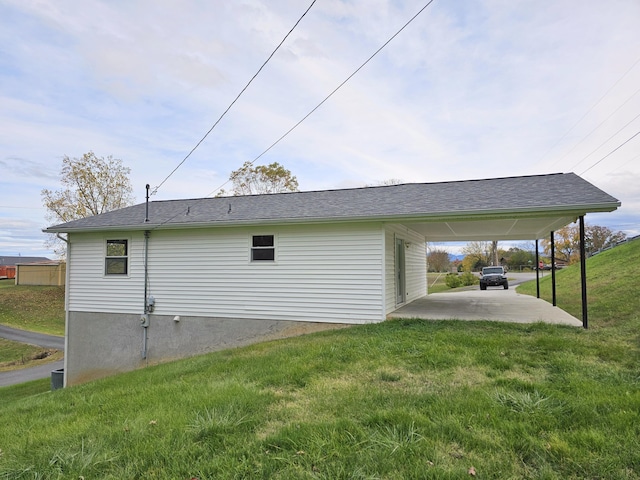 view of side of home with a carport and a yard