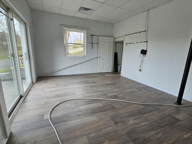 spare room with a paneled ceiling, basketball court, and wood-type flooring