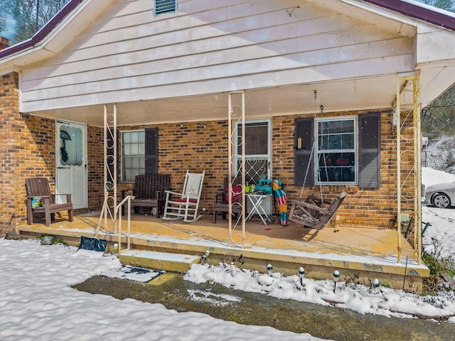 245 Fox Branch Rd, Kyles Ford, TN 37765 - snow covered house featuring brick siding and a wooden deck