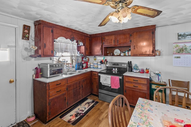 245 Fox Branch Rd, Kyles Ford, TN 37765 - kitchen featuring stainless steel electric range, light wood-style flooring, a ceiling fan, light countertops, and open shelves