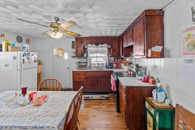 245 Fox Branch Rd, Kyles Ford, TN 37765 - kitchen featuring freestanding refrigerator, electric range, light countertops, light wood-style floors, and a ceiling fan
