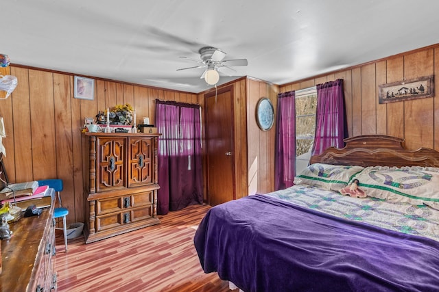 245 Fox Branch Rd, Kyles Ford, TN 37765 - bedroom with wood walls, light wood finished floors, and ceiling fan