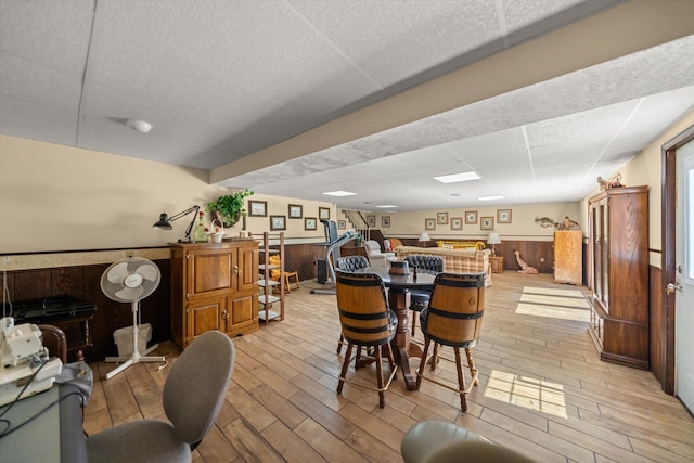 1869 Universal Rd, New Market, TN 37820 - dining room with a wainscoted wall, light wood-type flooring, wooden walls, and a drop ceiling
