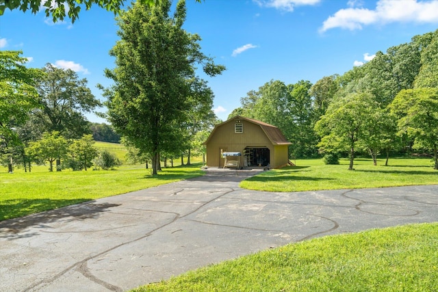 1869 Universal Rd, New Market, TN 37820 - view of front of house featuring a gambrel roof, a front lawn, an outbuilding, and view of scattered trees
