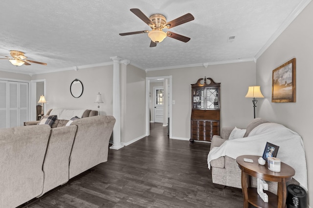 living area featuring ornate columns, a textured ceiling, baseboards, and dark wood-style flooring