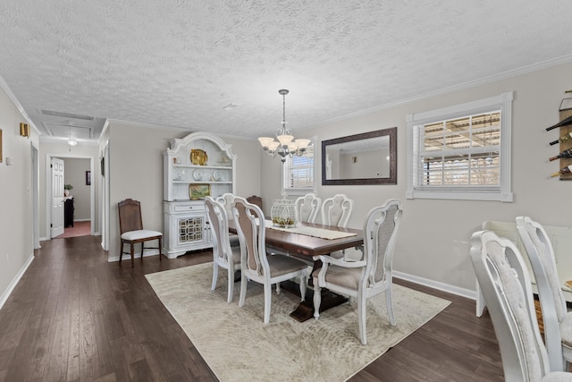 dining space with ornamental molding, dark wood-style flooring, a wealth of natural light, and attic access