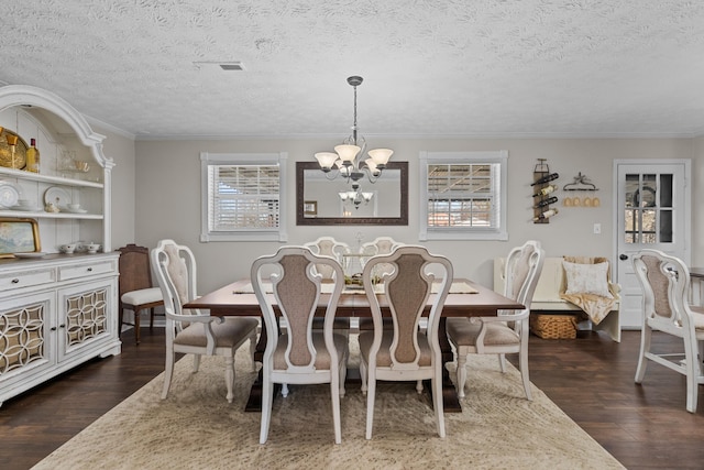 dining area featuring a textured ceiling, a chandelier, and dark wood-type flooring