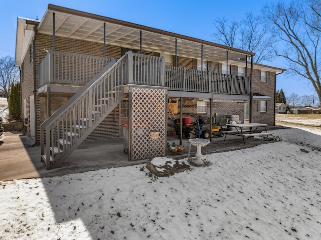 back of house featuring brick siding and stairway