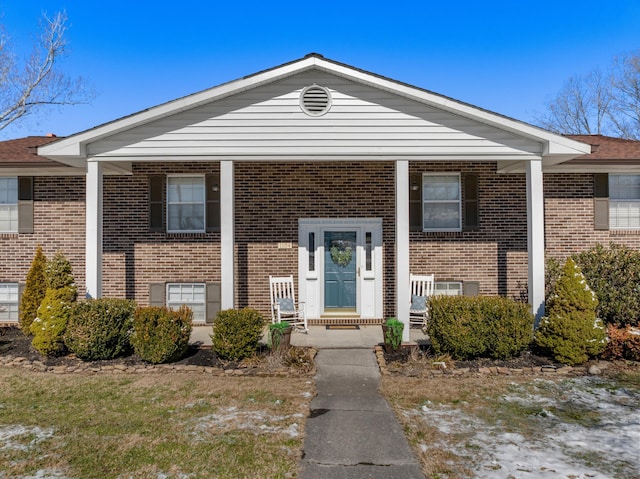 split foyer home featuring brick siding