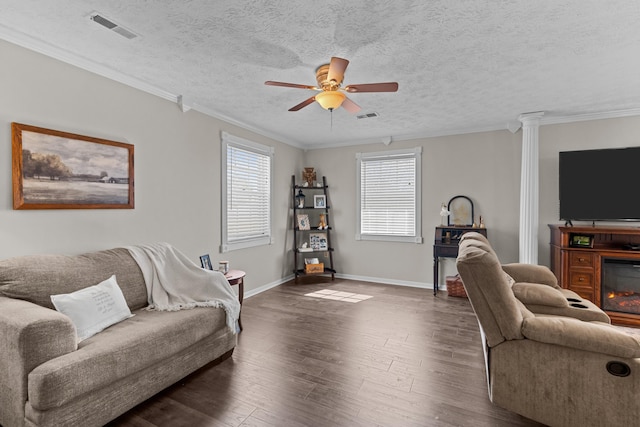 living room featuring dark wood finished floors, visible vents, and crown molding