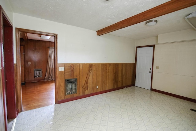 311 Locust St, Morristown, TN 37813 - unfurnished room with heating unit, light floors, wainscoting, wood walls, and a textured ceiling