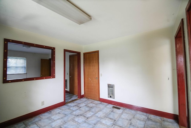 311 Locust St, Morristown, TN 37813 - unfurnished room featuring baseboards, stone finish floors, and heating unit