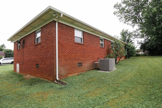 311 Locust St, Morristown, TN 37813 - view of side of property featuring cooling unit, a lawn, crawl space, and brick siding