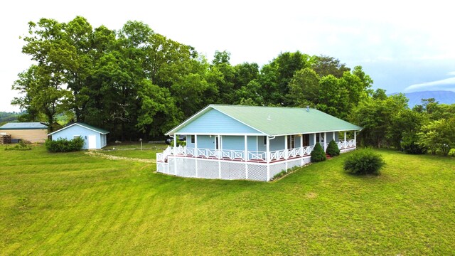 2131 Ted Moore Rd, Dandridge, TN 37725 - back of property featuring a porch, a lawn, a garage, and an outbuilding