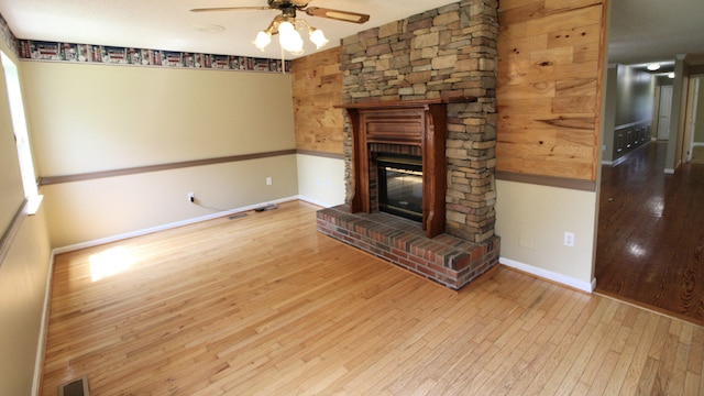 2131 Ted Moore Rd, Dandridge, TN 37725 - unfurnished living room with wood-type flooring, a ceiling fan, and a glass covered fireplace