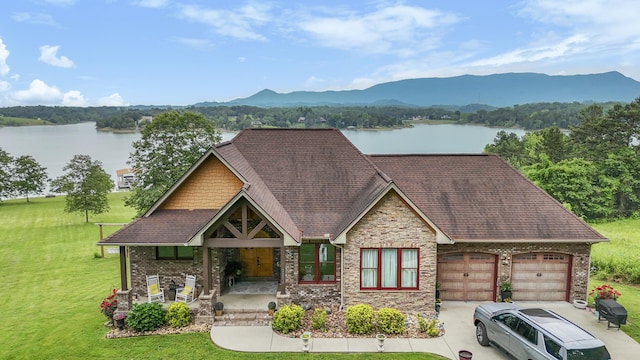 2224 Ted Moore Rd, Dandridge, TN 37725 - view of front of home with a front lawn, an attached garage, a water and mountain view, and roof with shingles