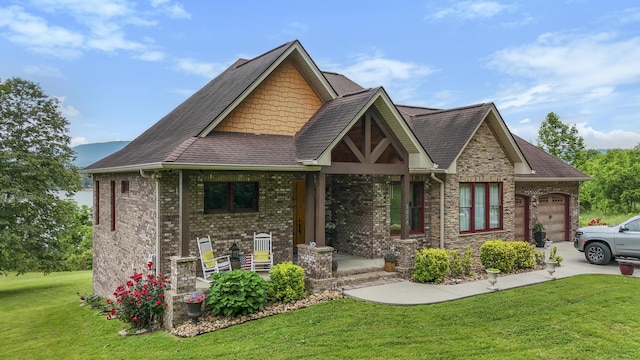 2224 Ted Moore Rd, Dandridge, TN 37725 - craftsman-style home with a garage, a front yard, driveway, and a shingled roof