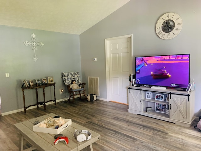 living room featuring hardwood / wood-style floors and vaulted ceiling