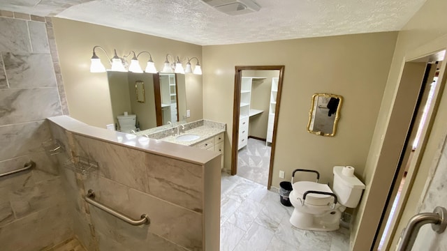 bathroom featuring toilet, marble finish floor, visible vents, and a textured ceiling