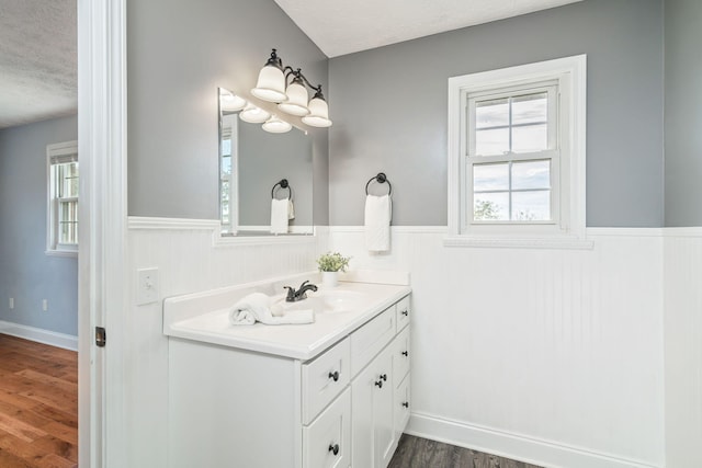 bathroom with vanity, a textured ceiling, and hardwood / wood-style flooring