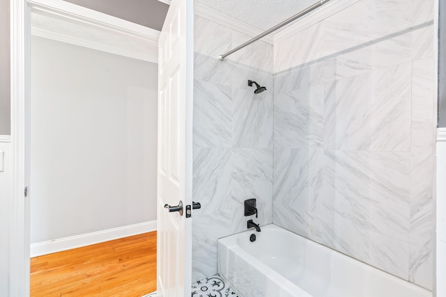 bathroom featuring wood-type flooring and tiled shower / bath combo