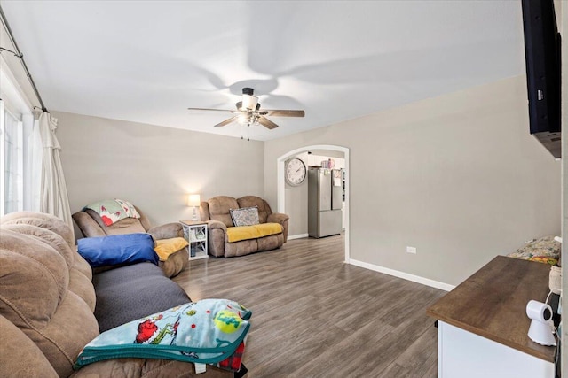 living room with dark hardwood / wood-style floors and ceiling fan