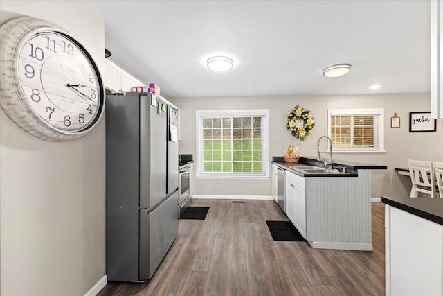 kitchen featuring white cabinetry, sink, dark hardwood / wood-style flooring, and appliances with stainless steel finishes