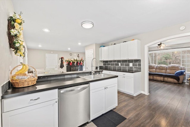 kitchen with tasteful backsplash, sink, white cabinets, and dishwasher