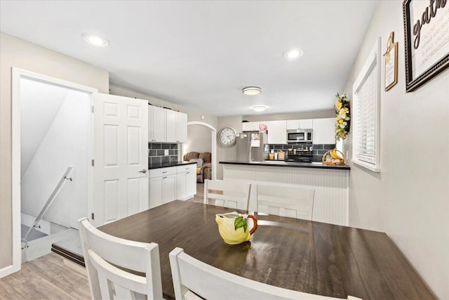 dining space featuring light wood-type flooring