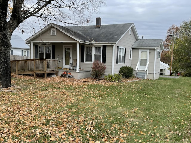 back of property featuring a lawn